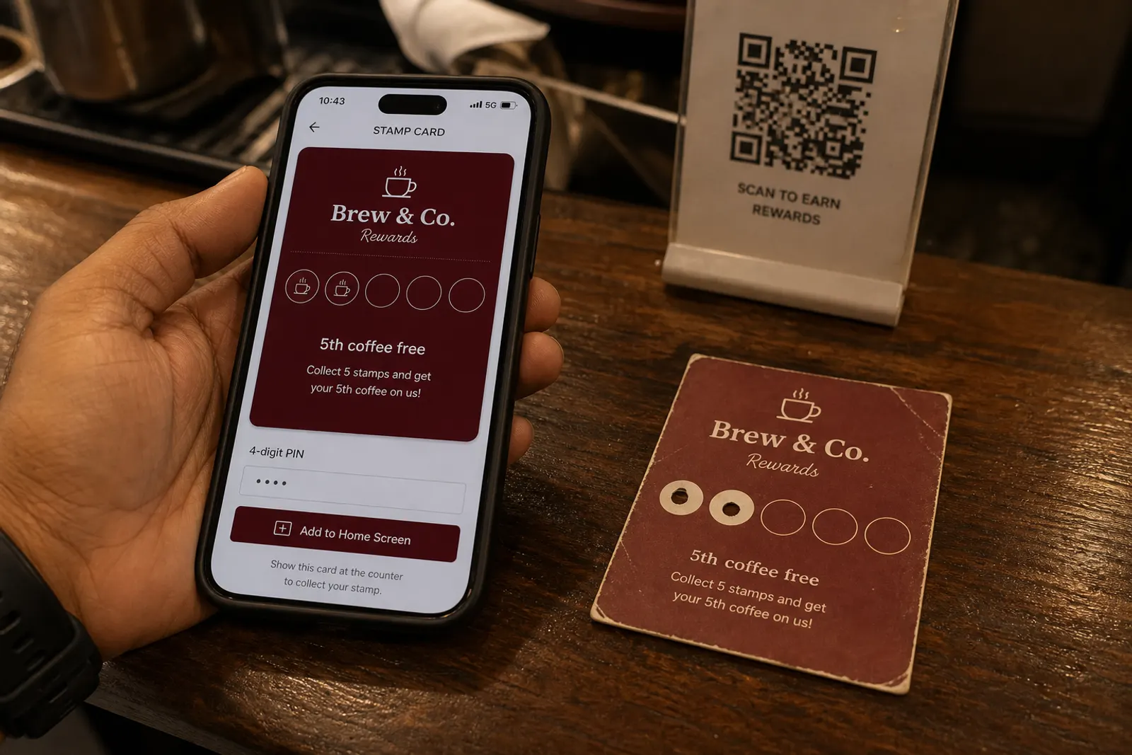Paper punch card next to a phone stamp card on a cafe counter