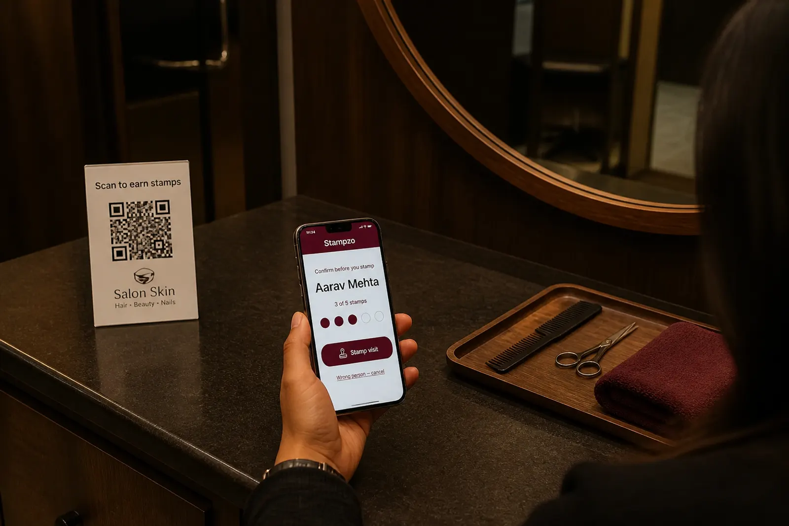 Salon reception desk with one QR stand and a phone